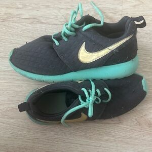 Nike Kids Black and Gold Sneakers with Teal Accents
